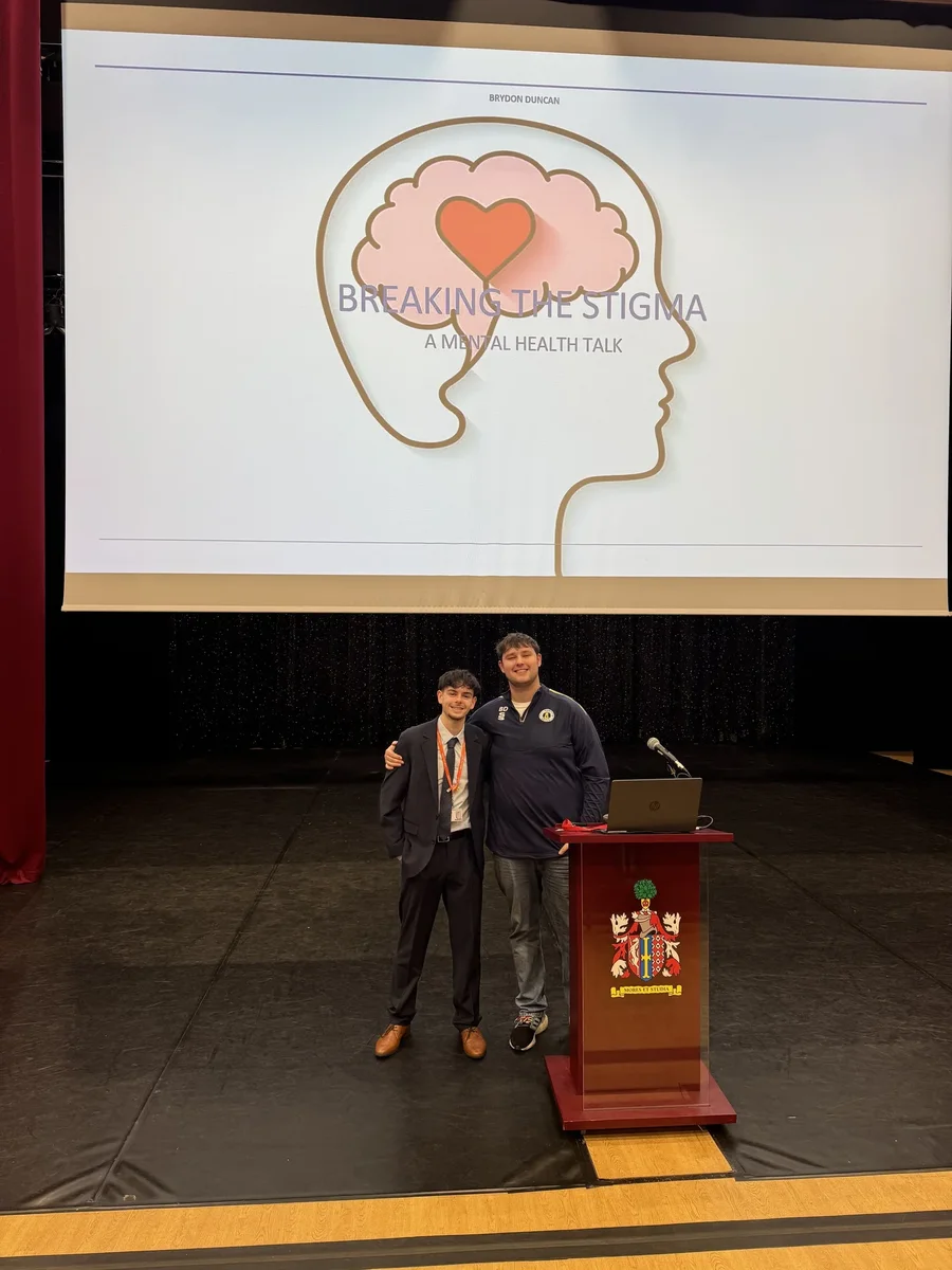 Brydon Duncan with a student after delivering a Breaking the Stigma mental health talk on stage